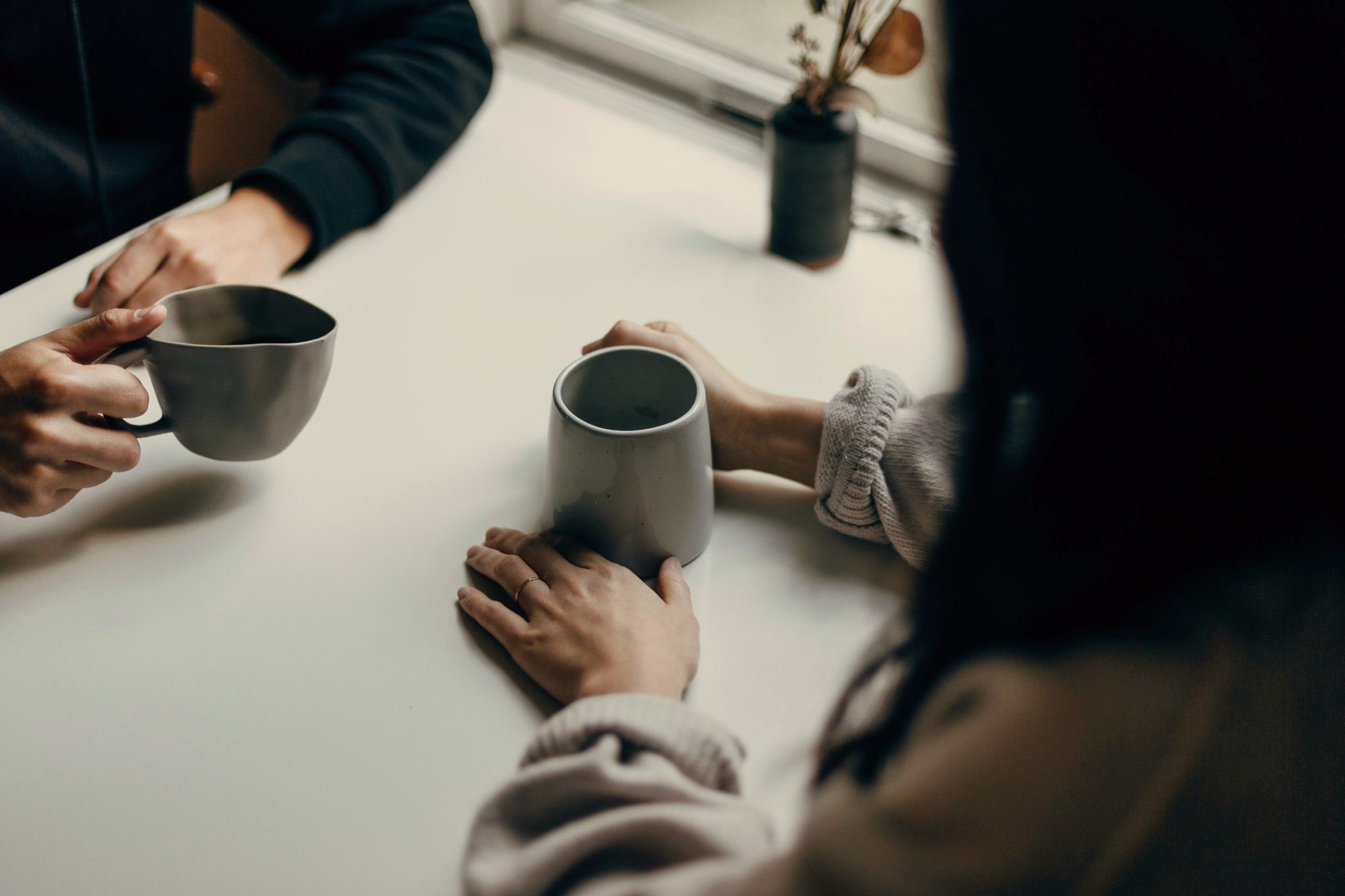 A man and woman drinking coffee at work